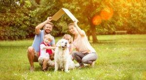 9 Best Resources for First Time Home Buyers - family with their dog sheltering under a roof to illustrate home concept